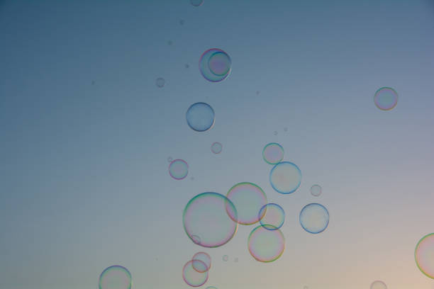 Many colorful soap bubbles float in the sky