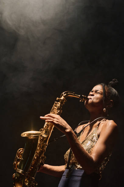 istock Black woman playing saxophone on stage 2008322245