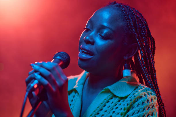 istock Close Up Black Woman Singing into Microphone 2008322782