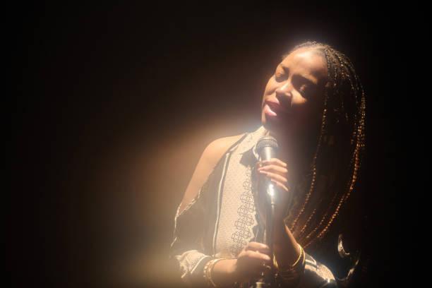 istock Black Woman Singing in Glowing Spotlight 2008322785