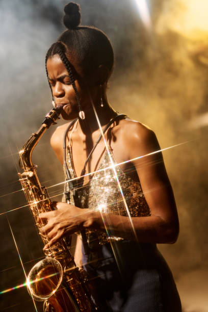 istock Talented Woman Playing Saxophone with Golden Light 2008323371