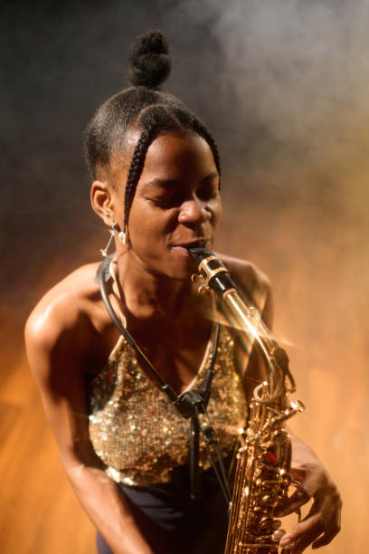 istock Passionate Black young woman playing saxophone 2008323375