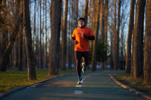 istock Man running in the park in wintertime 2008328153