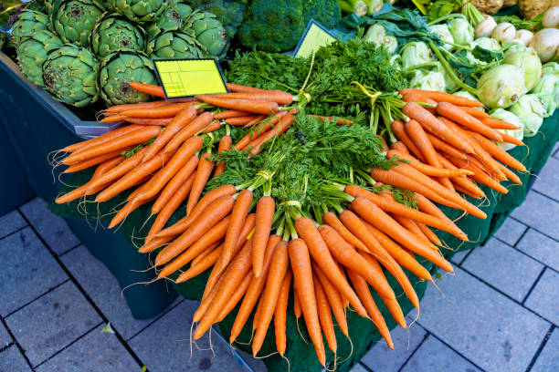 Bunch of carrots are on display at farmers market for sale stock photo