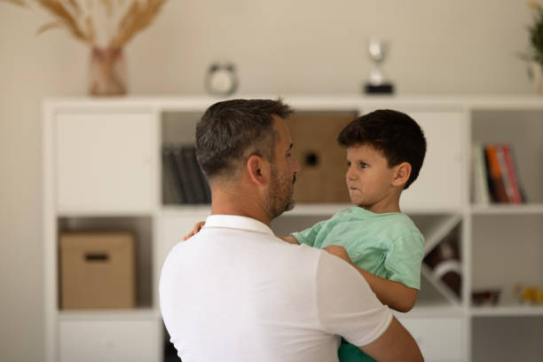 istock Affectionate little boy and his father embracing at home. 2008360894
