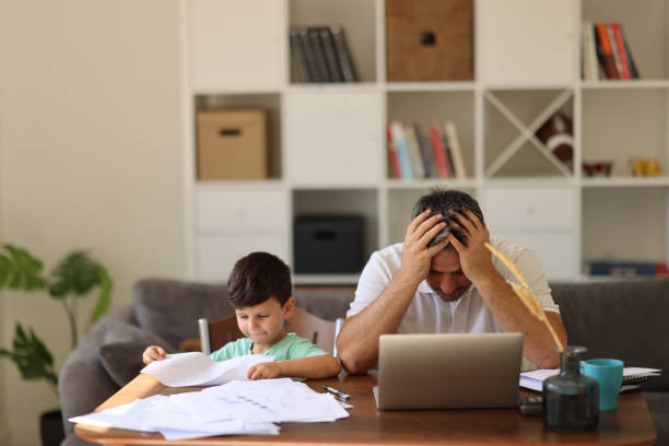 istock Stressed Man With his two years old son Working From Home 2008361422