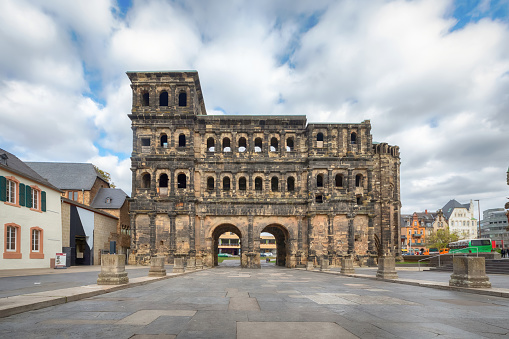 Trier, Germany. View of Porta Nigra - Grand Roman city gate dating from 180 AD with towers made from heavy stone slabs
