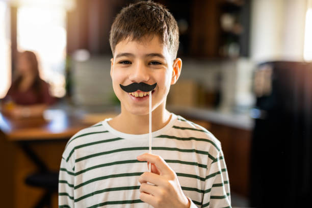 istock Kid playing with fake mustache 2008428369