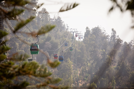 The gondolas of the Teleferico cable car in Santiago de Chile on San Cristobal Mountain disappear into the city's smog.