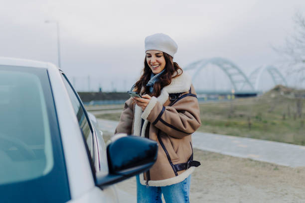 istock Young  woman getting into the car 2008451436