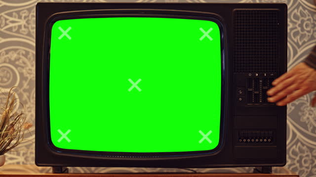 LD Old TV set with a green screen being tuned off