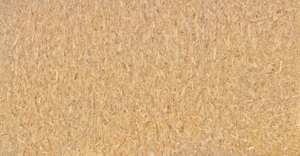 Panoramic close-up of a very large OSB chipboard Panoramic close-up of a very large OSB chipboard - brown abstract wood texture pressboard stock pictures, royalty-free photos & images