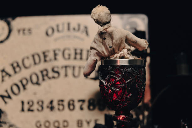 istock A dark atmospheric setting with an Ouija board, candles, and mystical objects invoking a sense of the occult. 2008498478