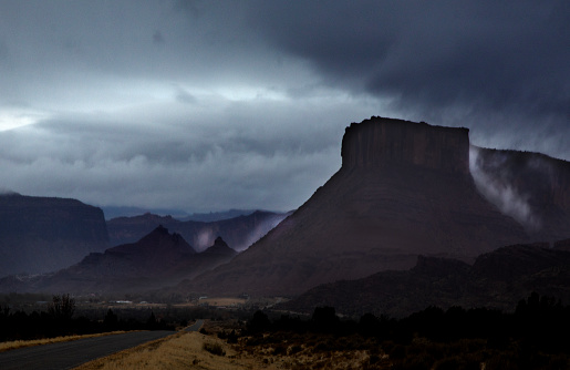 A passing rainstorm brings some clouds, fog and  dramatic looks to the landscape at Castle Valley, Utah