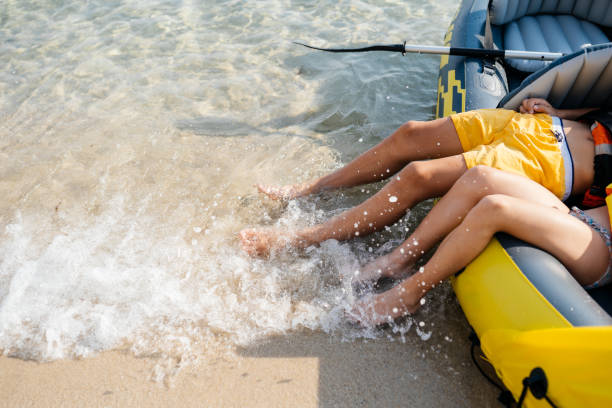 teenagers having fun with inflatable raft on their summer vacation - child inflatable raft lake family fotografías e imágenes de stock