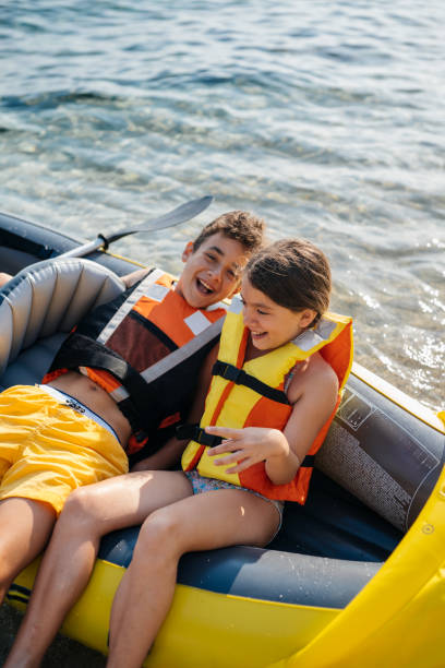 Active teenagers having fun with inflatable raft on their summer vacation