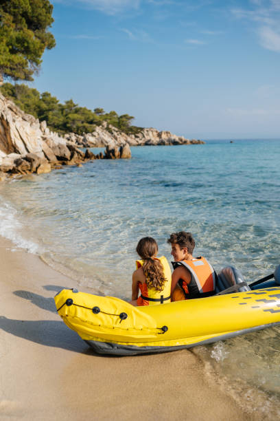 istock Teenagers having fun with inflatable raft on their summer vacation 2008575708
