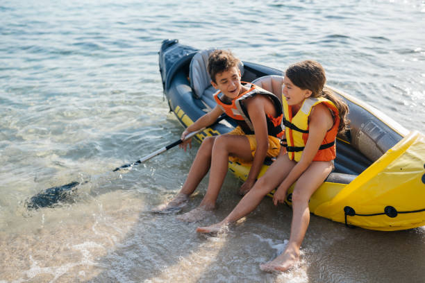 teenagers having fun with inflatable raft on their summer vacation - child inflatable raft lake family fotografías e imágenes de stock