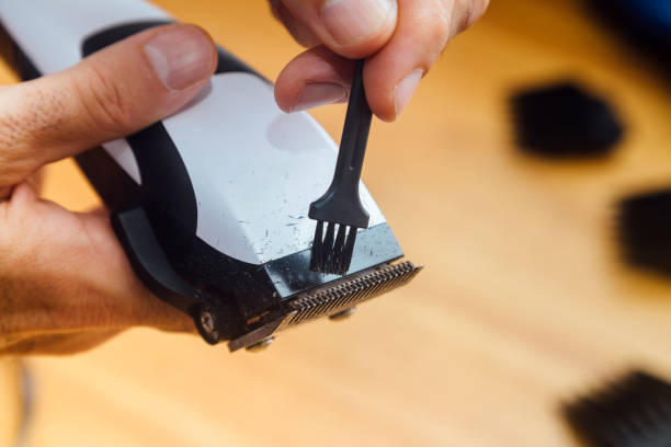 istock Barber cleaning his clipper. Close up view. Maintenance of work tool. 2008620783