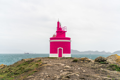 Pink lighthouse at the shore