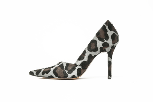 Leopard print calf hair pumps isolated on white. Classic animal print heels with sharply pointed toes.