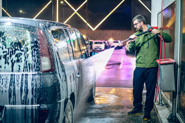 istock A man washes his car at a self-service car wash using a hose with pressurized water 2008676974