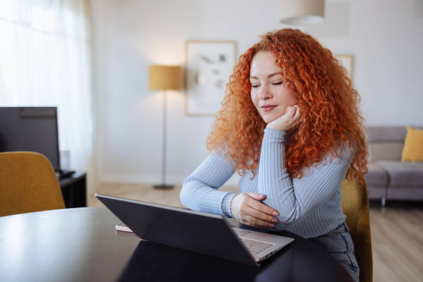istock Young beautiful woman using laptop at home 2008771354