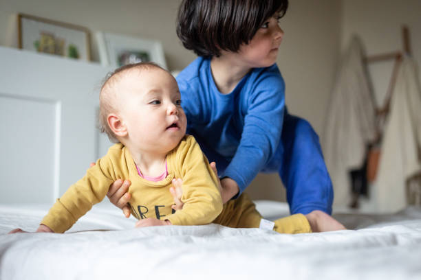 istock two children playing on the bed watching arriving of parent 2008772807