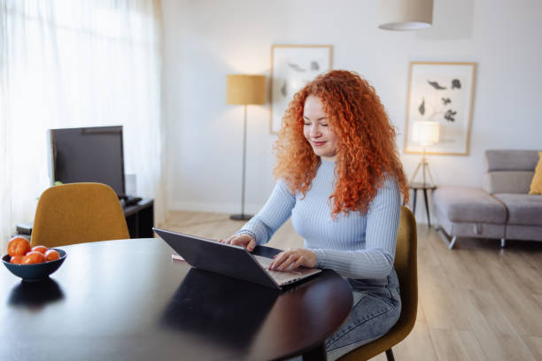 istock Young beautiful woman using laptop at home 2008773344