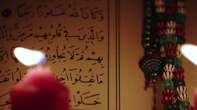 Religion The Book of Islam Quran in Candle Light