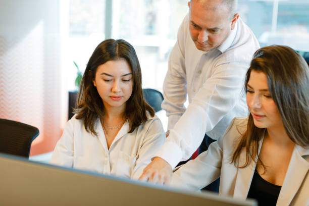 istock Dynamic Business Collaboration: Multiracial Business Team Engaged in a Productive Staff Meeting. Diverse Group  Planning Strategically, Brainstorming, Collaborating, and Working a Modern Office Setting 2008829201