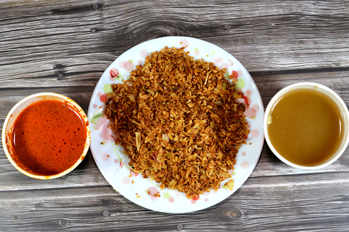 Fried onions, spices and peppers sauce called Shatta and Cumin vinegar sauce, Also called Dakkah sauce, made of white vinegar, ground cumin, crushed garlic, very popular in Egypt for Koshary cuisine, selective focus