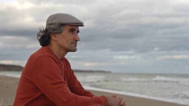 istock Man by the sea, daydreaming. People in nature. copy space 2008905020