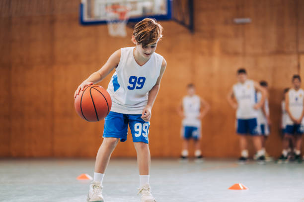 istock A junior athlete is practicing basketball on training at indoor court. 2008915572
