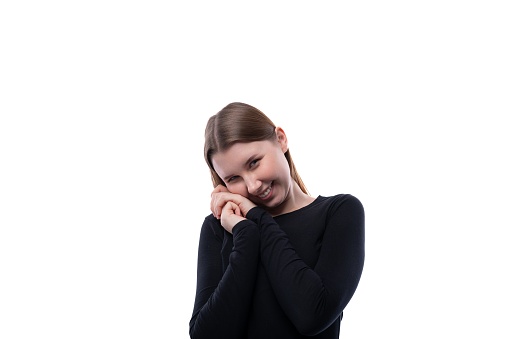 Portrait of a shy preteen girl of European appearance on a white background.