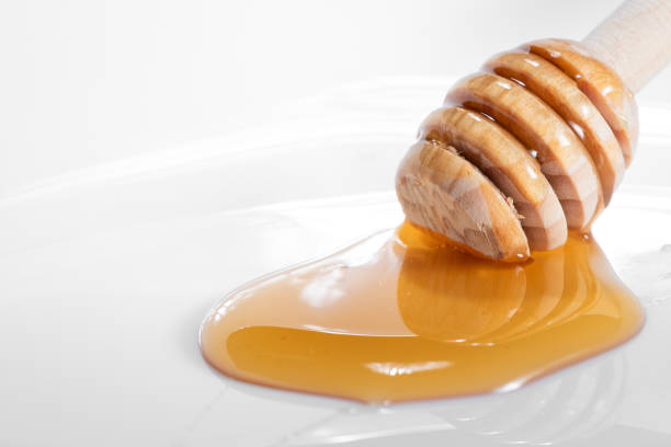 istock Wooden honey dipper stick 2008993798
