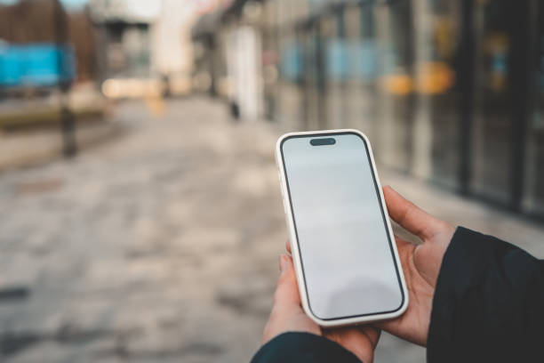 istock Mobile App Advertisement. The girl is holding a smartphone with a blank screen in her hand. Place for text on smartphone. Mocap 2009004996