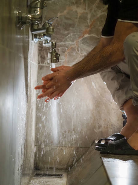 man in the mosque washes before prayer