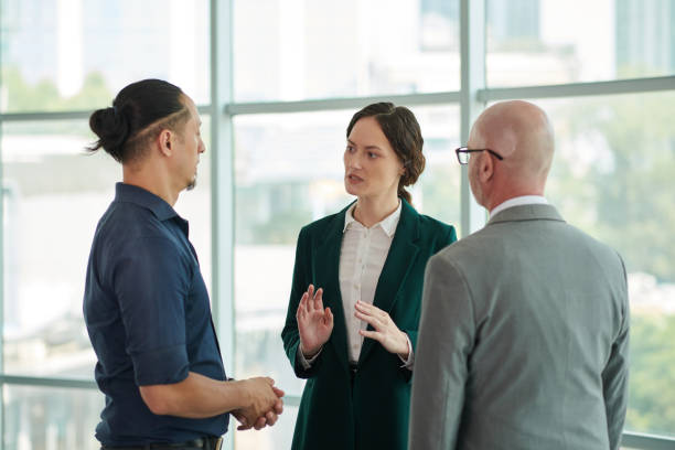 istock Confident woman talking to colleague 2009030230