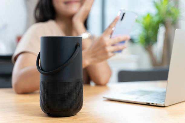 istock Close-up on hand using phone connecting portable speaker. Black Portable Wireless Bluetooth Speaker for Music. 2009052833