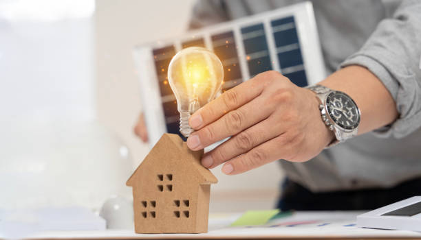 istock Concept working for clean energy and saving power in nature. hand holding light bulb on the house model and solar panel. 2009053341