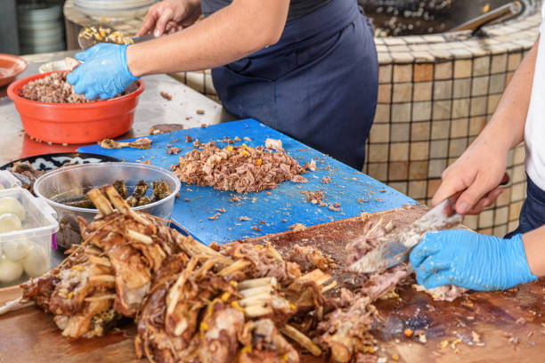 istock Cookers are cutting meat from plov (pilaf) for serving, Tashkent 2009097645