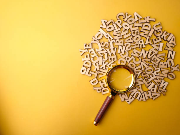istock Vintage magnifying glass and wooden word 2009101800