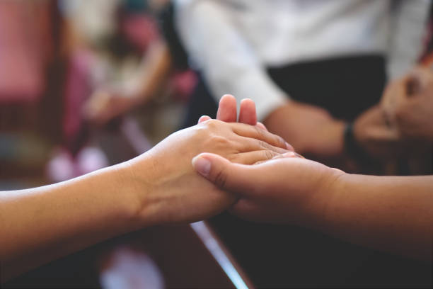 istock A couple hands praying and caring together at Church. 2009115004