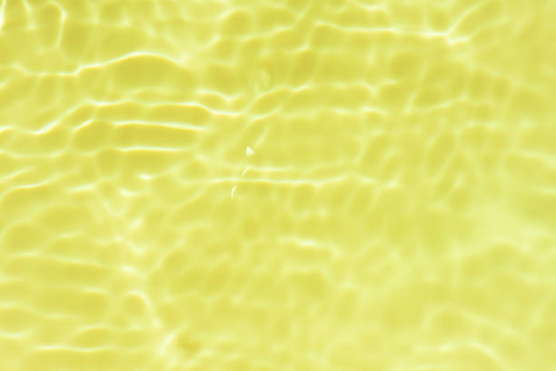 istock Water surface. Orange water waves on the surface ripples blurred. Transparent blue colored clear calm water surface texture with splash and bubbles. Water waves with shining patterns. 2009138177