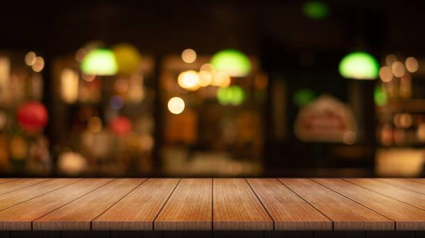 istock Empty wooden table top with lights bokeh on blur restaurant background. 2009174104