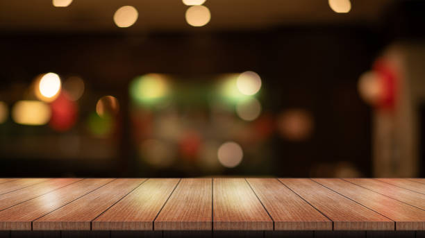 istock Empty wooden table top with lights bokeh on blur restaurant background. 2009174108