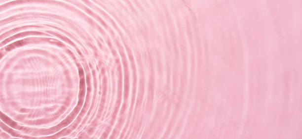 istock Water ripples on pink background. Abstract water ripples texture. 2009186648