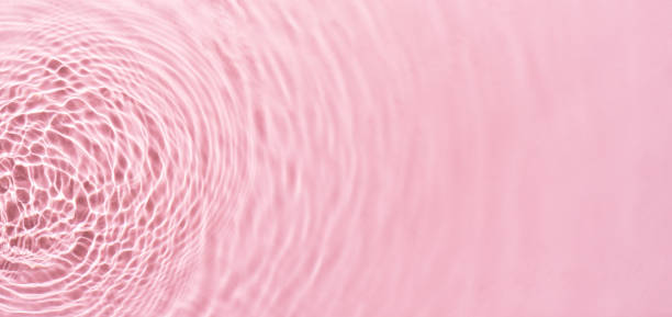 istock Water ripples on pink background. Abstract water ripples texture. 2009187154