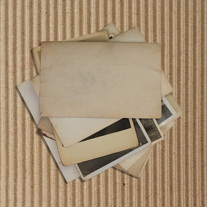 Vintage photo stack on a sheet of cardboard
